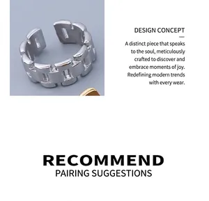 Macro detail of silver-toned H-link chain style open ring in minimalist punk design