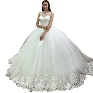 Luxurious white ball gown wedding dress with lace appliques and sheer neckline details