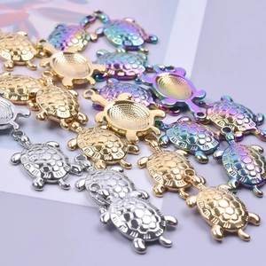 Turtle-shaped stainless steel pendants in gold, silver, and iridescent finishes