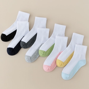 Detail showing eight pairs of white cotton socks with colorful toe and heel patches