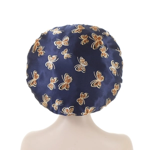 Elastic satin sleeping bonnet in dark blue featuring a golden butterfly pattern print