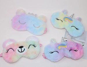 Detailed view of four colorful plush sleep masks with unicorn and animal embroidery