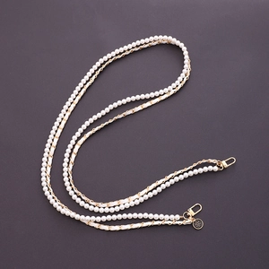 Double-layer pearl and gold metal chain strap featuring a black camellia floral charm