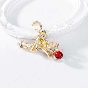 Back view of gold alloy reindeer brooch with red bell and secure safety pin buckle