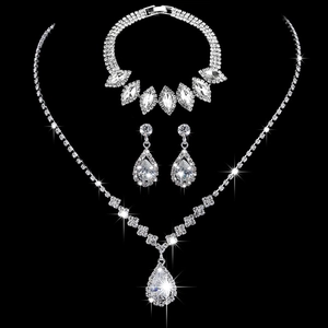 Elegant bridal jewelry set with silver necklace, bracelet, and earrings featuring sparkling crystals