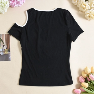 Close-up of black cutout shoulder t-shirt with white trim on floral background