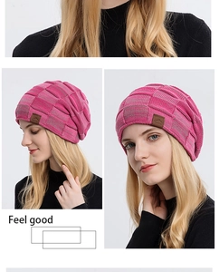Detail view of pink knit beanie with checkered pattern and premium leather mountain patch