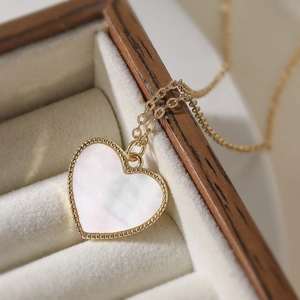 Elegant 18K gold plated heart necklace with white shell inlay and beaded gold edges