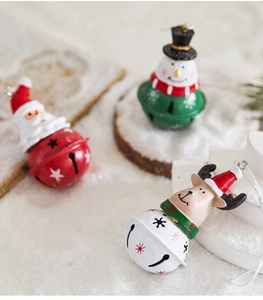 Detailed view of metal Christmas bells with Santa, Snowman, and Reindeer figurines