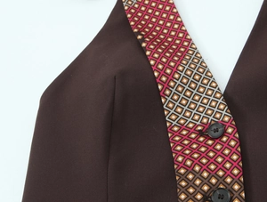 Macro view of dark brown geometric pattern fabric with high-quality black button detail