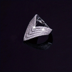 Macro shot of V-shaped ring with full pave cubic zirconia on black reflective surface