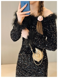 Detailed view of snail shell shaped gold metallic crossbody bag and chain strap