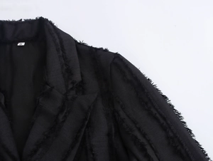 Detail of black double-breasted coat with unique fringe texture and size S collar label