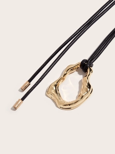 Minimalist long black cord necklace featuring an irregular gold organic loop pendant