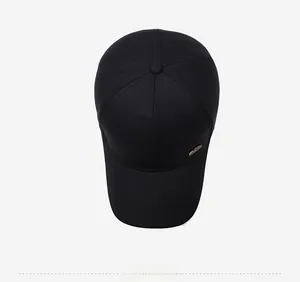 Top view of a classic black six-panel cotton baseball cap with a small metal side logo