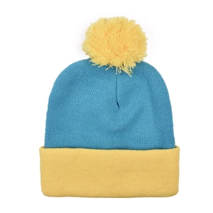 Detail of blue and yellow knitted beanie featuring a large fluffy top pom-pom