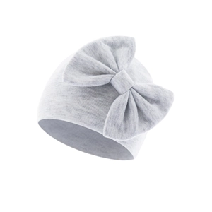 Detail of light grey knit baby hat with a large decorative bow and soft texture