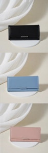 Three long tri-fold wallets in black, blue, and pink colors with metal hardware buckle