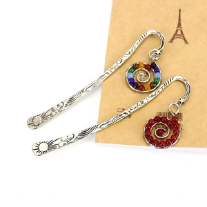 Handmade metal bookmarks with sun motifs and colorful bead tassels in retro style