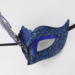 Detail of blue and black masquerade mask with glitter finish and elegant scrollwork
