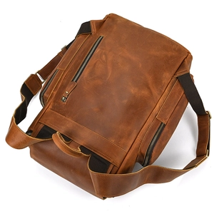 Rear view of brown crazy horse leather backpack showing straps and top handle detail