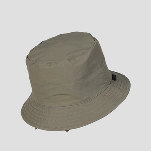 Detail of olive green quick-dry nylon bucket hat with reinforced stitching and side label