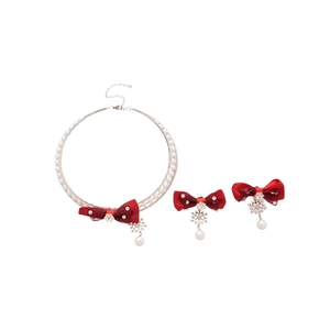Elegant jewelry set with red fabric bow, snowflake pendants and white pearl necklace