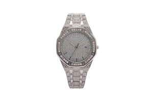 Close-up of octagonal bezel and date display on a full iced-out silver wrist watch