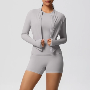 Detail of grey three-piece yoga set featuring thumbhole cuffs and high waist fitness shorts