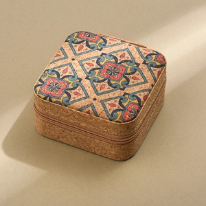 Detail view of portable cork jewelry box with vintage floral pattern and metal zipper