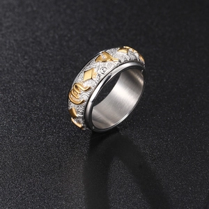 Rotating stainless steel spinning ring with embossed gold pattern and silver base
