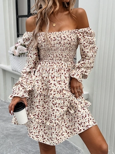 Floral dress detail with off-shoulder design, long sleeves and ruffled hem on beige fabric