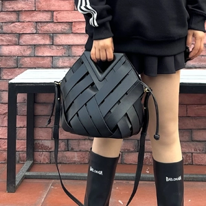 Chic black woven leather basket bag with magnetic clasp and adjustable crossbody strap