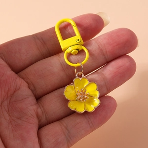 Yellow enamel flower keychain with gold stamens and matching metal spring hook