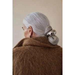 Chic silver metallic ponytail holder cuff with a minimalist large ring design on long hair