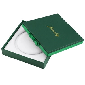 Dark green jewelry box with ribbon bow and gold lettering for rings and necklaces