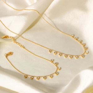Gold stainless steel jewelry set with white zircon tassel necklace and bracelet on silk