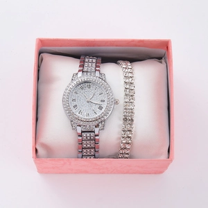 Close-up of silver diamond watch and tennis bracelet set in a pink gift box