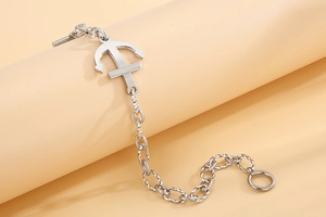 Detail of silver stainless steel anchor pendant and twisted link chain with OT clasp