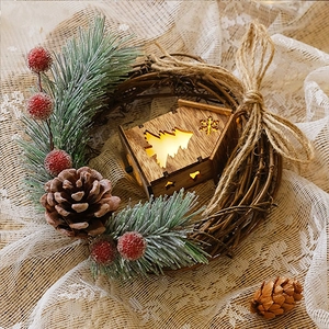 Christmas wreath with LED wooden house, pine needles, berries, and cones for door decor