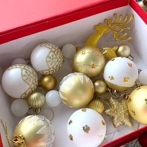 Dettaglio set natalizio con renne, stelle e palline glitterate color oro e bianco