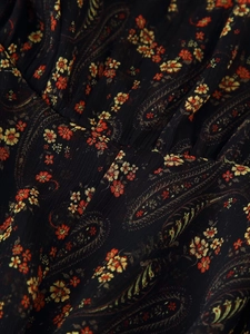 Detail of floral paisley print on pleated seersucker fabric with vibrant colorful patterns