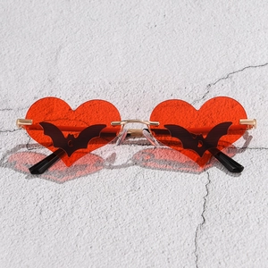 Detail of red heart lenses with black bat silhouettes and gold metal frames