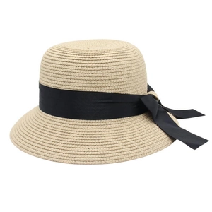 Close-up of fine spiral weave straw sun hat with an elegant black grosgrain ribbon bow