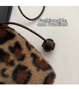 Macro detail of leopard print faux fur bucket bag with leather drawstring and knot