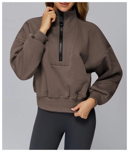 Detail of half-zip high neck taupe sweatshirt with heavy cotton fabric and ribbed cuffs