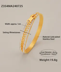 Macro detail of 18k gold plated zipper bangle with shimmering rhinestone accents