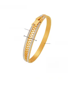 Macro detail of 18k gold plated zipper bangle with shimmering rhinestone accents