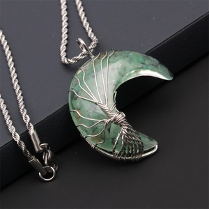 Detailed close-up of handmade tree of life wire-wrapped green crescent moon pendant necklace