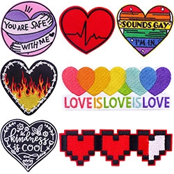 Macro view of assorted colorful embroidered punk patches with rainbow and heart designs